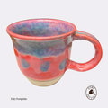 A handmade ceramic coffee mug with a vibrant, multicolored glaze featuring red, blue, and purple hues, with a small beige foot-shaped base detail. The mug is shown on a light gray background with the brand logo 'Fairy Footprints' in the bottom left and a circular logo in the bottom right. Brisbane Pottery Australian Pottery.