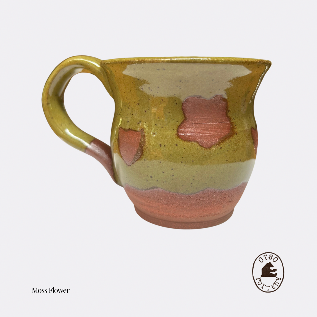 Handmade ceramic pottery mug by Otso Pottery otso pottery Brisbane Australia rose swirl handmade ceramic mug with a glossy glaze featuring a yellow-green top section, a pale beige middle band, and terracotta pink accents, labeled 'Moss Flower' with a 'Two Coffee' logo on a light gray background.