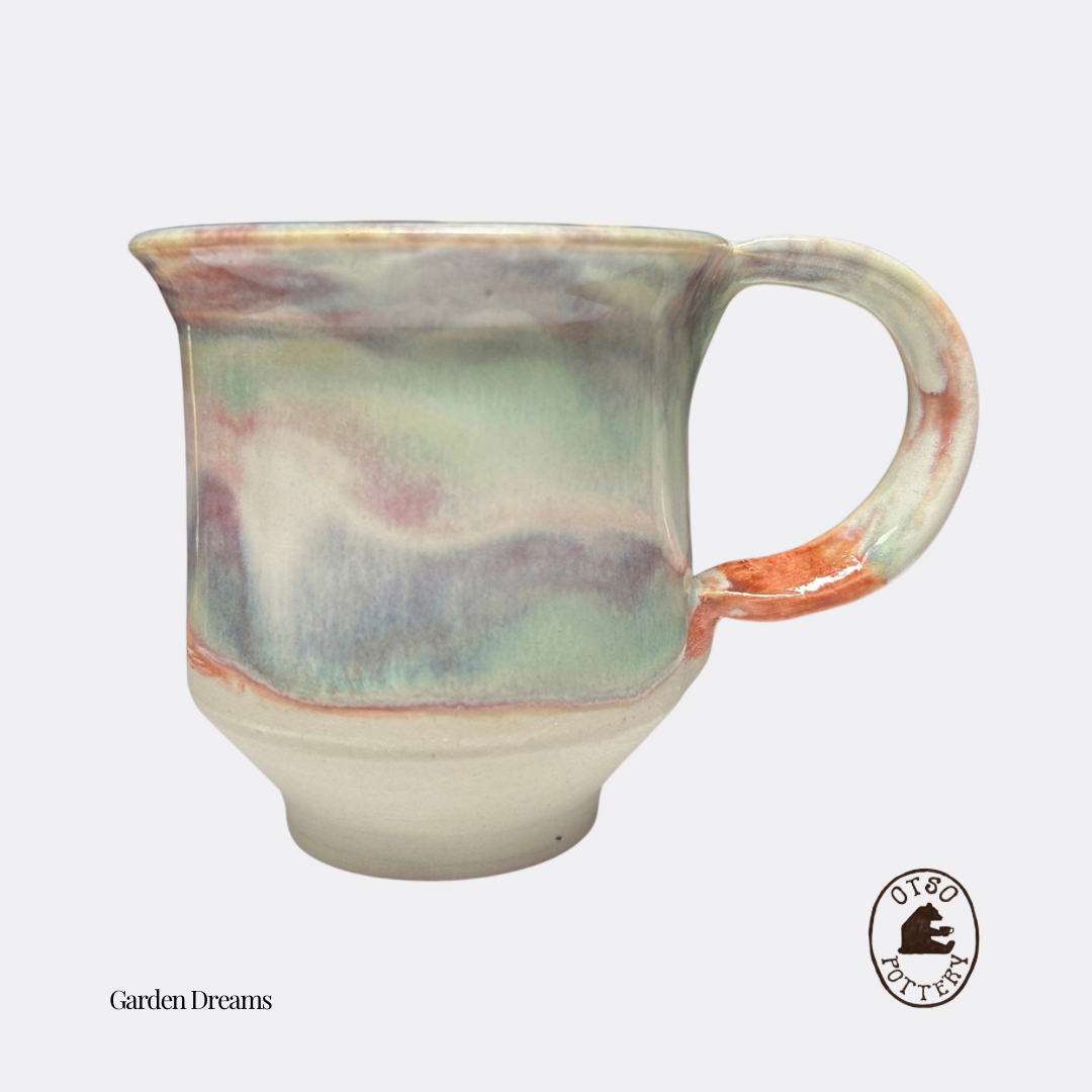 Handmade ceramic pottery mug by Otso Pottery otso pottery Brisbane Australia rose swirl  handmade ceramic mug with a marbled, watercolor-like glaze in pastel shades of green, blue, pink, and orange on a light gray background.