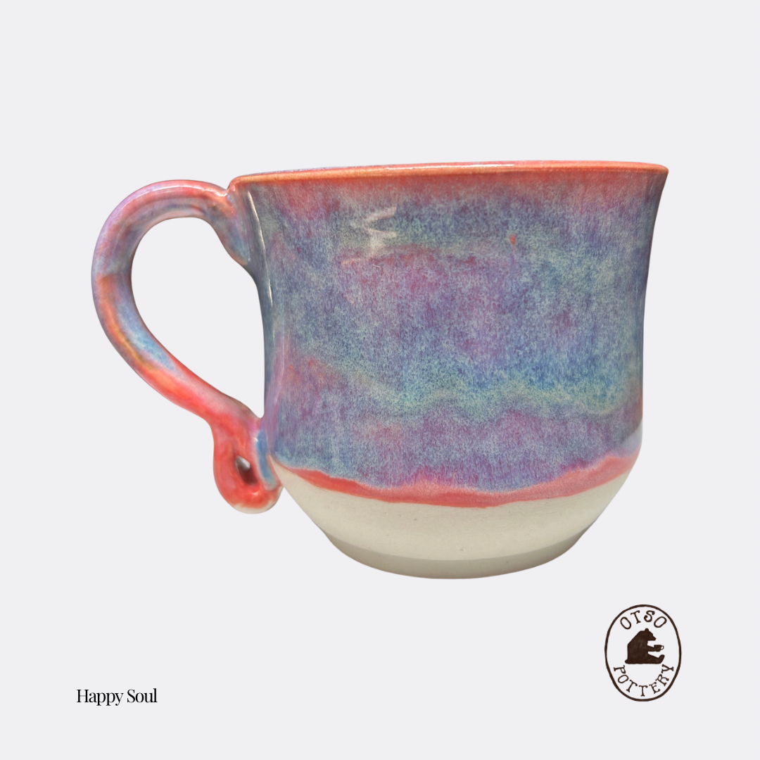 Handmade ceramic pottery mug by Otso Pottery otso pottery Brisbane Australia rose swirl A handmade ceramic coffee mug with a multicolor glaze featuring shades of blue, purple, pink, and red, with a solid cream-colored base. The mug is shown on a light gray background with a 'Happy Soul' text label and a bear logo in the bottom right corner.