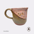 Handmade ceramic pottery mug by Otso Pottery otso pottery Brisbane Australia rose swirl  A handmade ceramic coffee mug with a handle, featuring a diagonal split design in earthy tones of brown, bronze, and pink. The mug is shown on a light gray background with a 'Moss and Bloom' text label and a 'Dino Coffee Co' logo in the bottom right corner.
